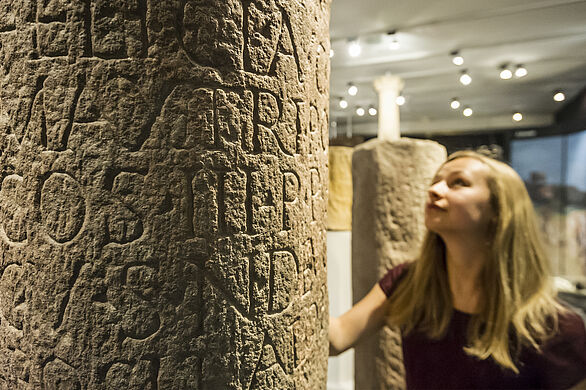 Photo of a Roman milestone with a Latin inscription