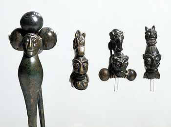 Fotografie von vier keltischen Maskenfibeln aus Bronze
