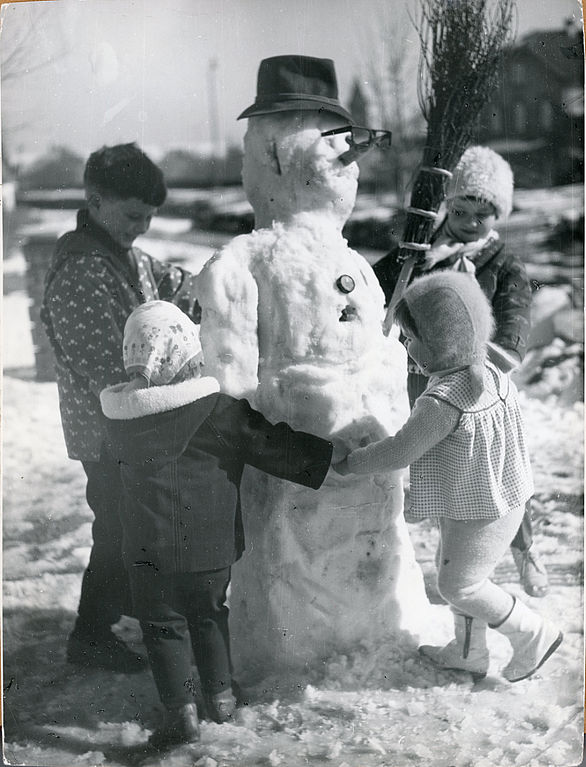Photos of children dancing around a snowman