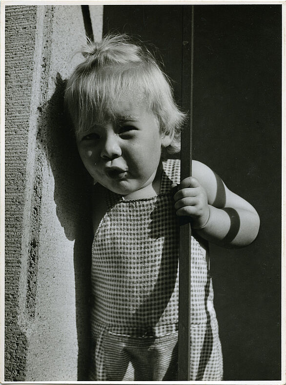 Photo of a girl at a house entrance