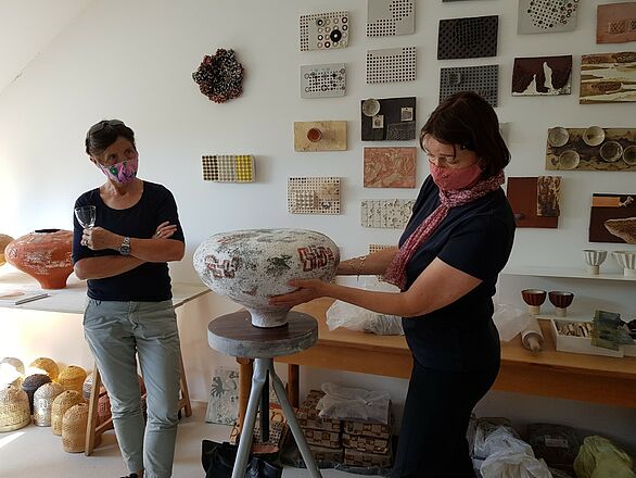 Keramikerin zweigt Frau, wie sie arbeitet anhand eines Objektes