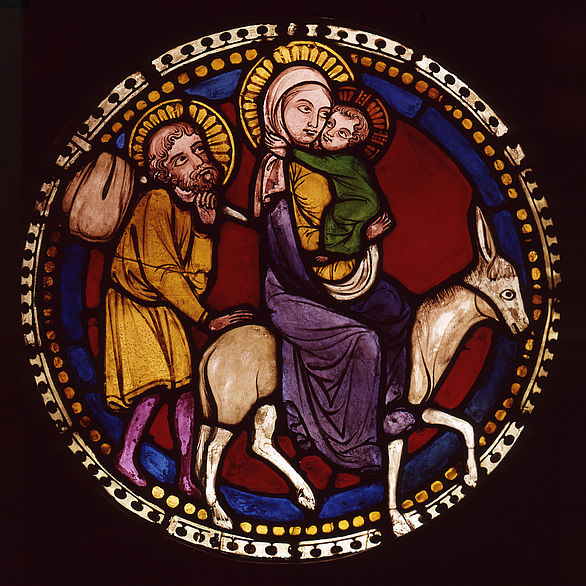 Stained glass window shows the child of Jesus fleeing to Egypt